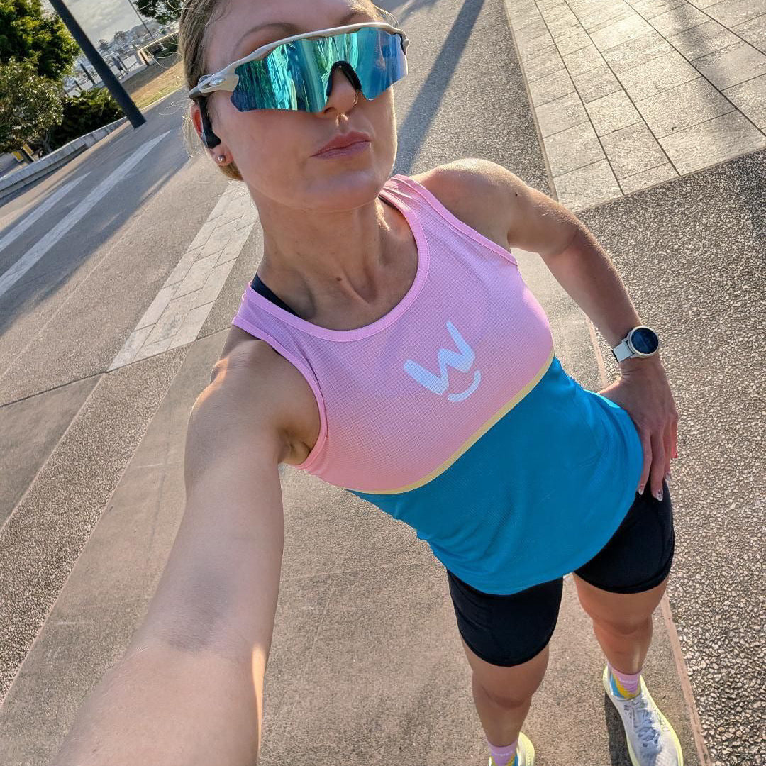 A runner wearing the Wippet Performance Running Singlet that is breathable, sweat wicking, ultra light weight about to do some marathon training