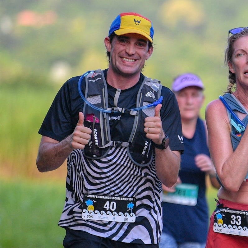 Man happily running a marathon wearing a Wippet Running Shirt that is sun protection, breathable, light and sweat wicking.