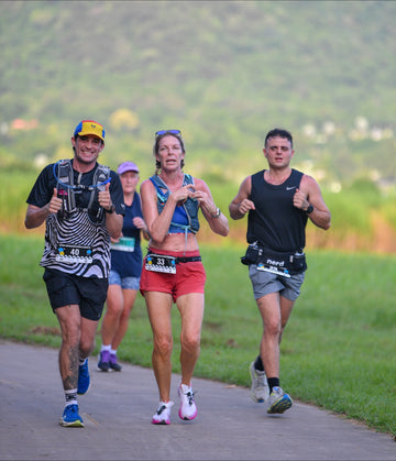 Male and female runners competing in the Brisbane Marathon wearing Wippet technical running tees and running caps with UPF50+ sun protection