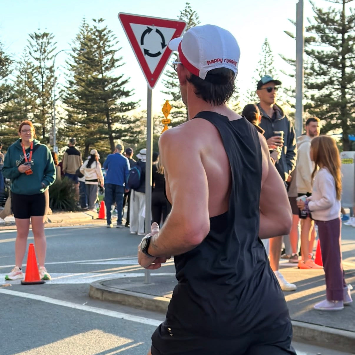Man running Gold Coast Marathon wearing Wippet's breathable, sweat wicking, ultra light weight, sun protective Redline running cap.
